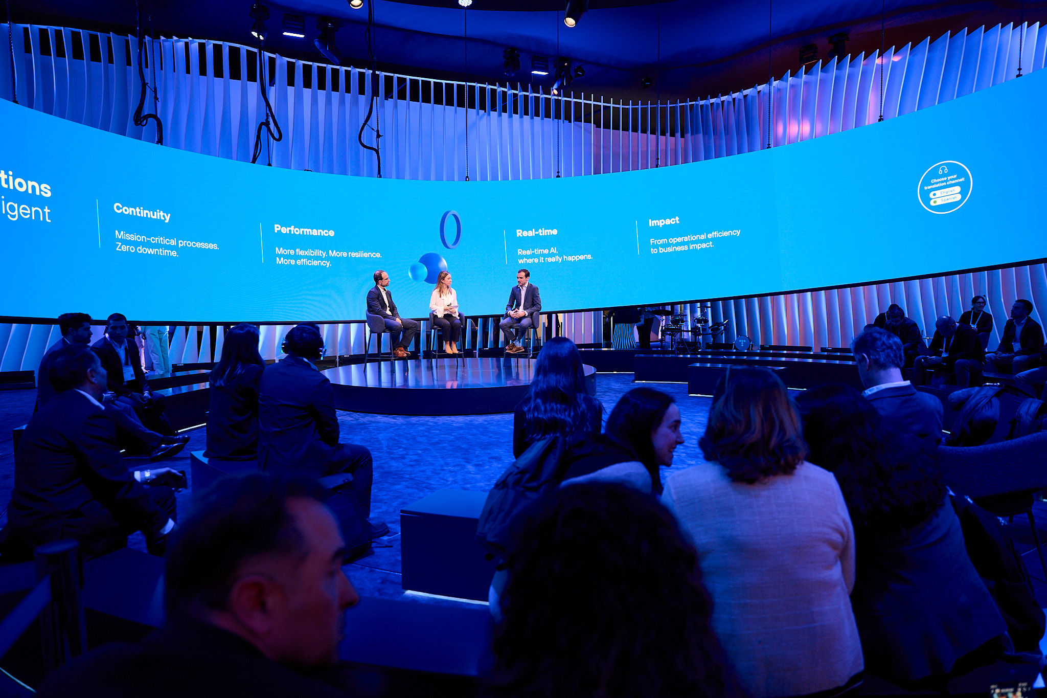 Business professionals attending technology conference keynote panel discussion